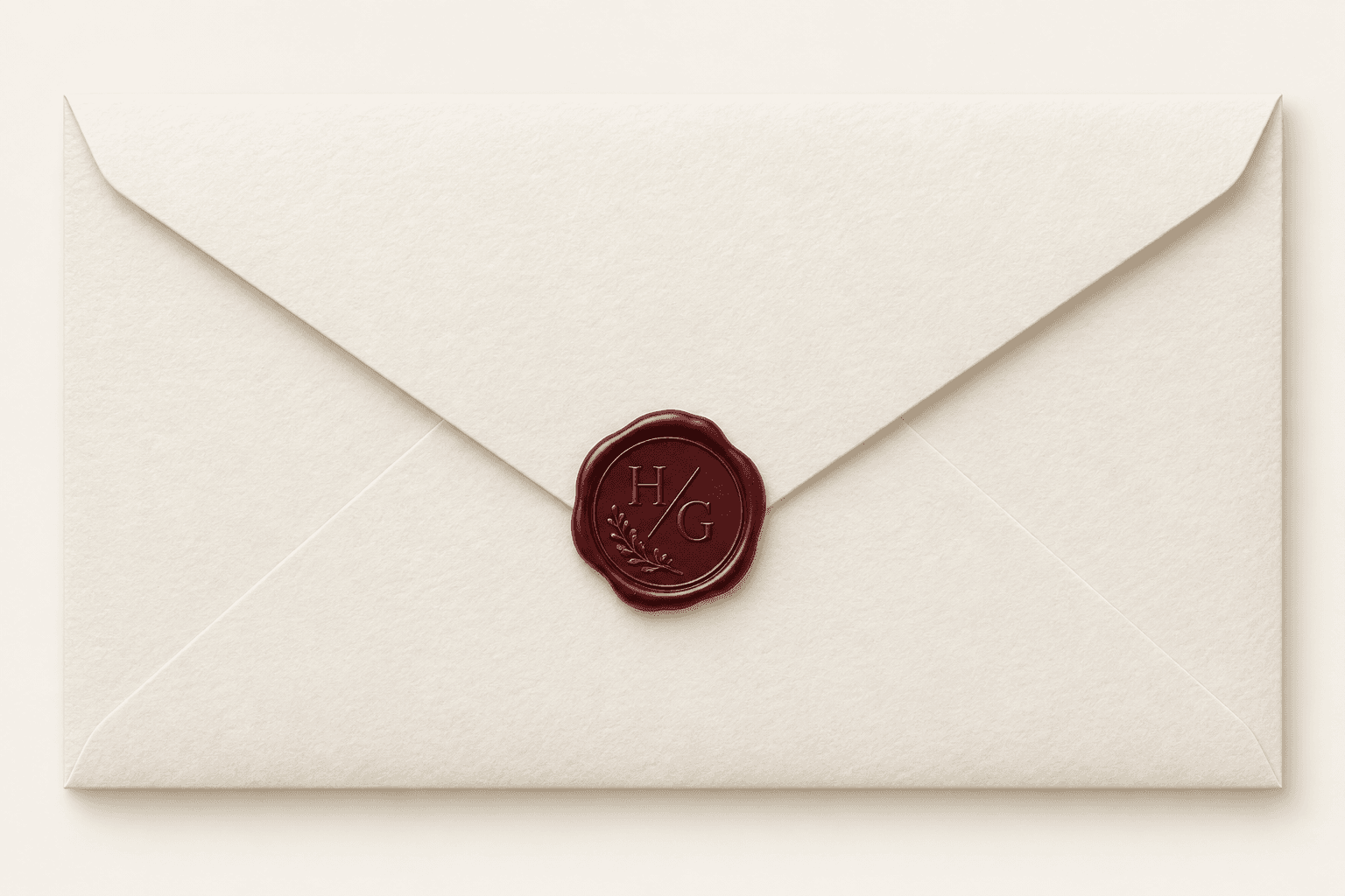 Ivory invitation envelope with a burgundy H/G wax seal